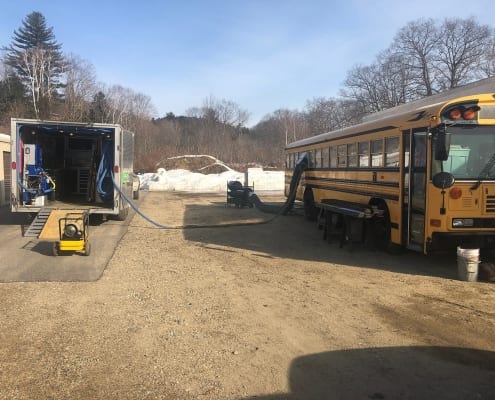 Spray foam insulation contractors NH doing a insulation job on a school bus